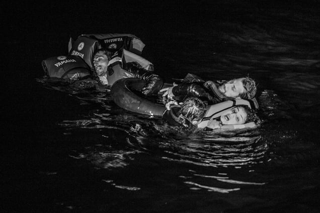 Syrian mother with her baby son along with a Syrian father holding his dead daughter after their boat capsized off the Greek coast