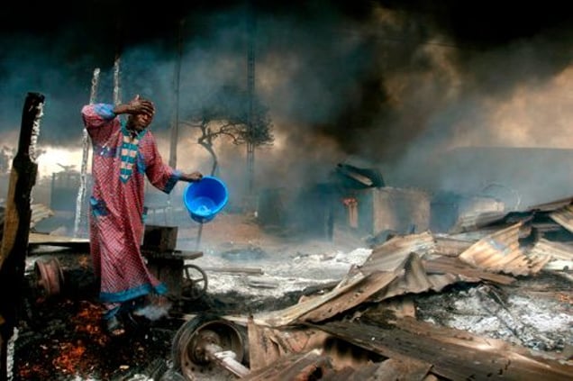 1st prize Spot News Singles, © Akintunde Akinleye, Nigeria, Reuters, Man rinses soot from his face after gas pipeline explosion, Lagos, Nigeria, 26 December
