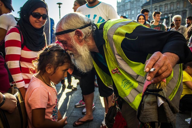 Hungarian homeless meets a little refugee girl