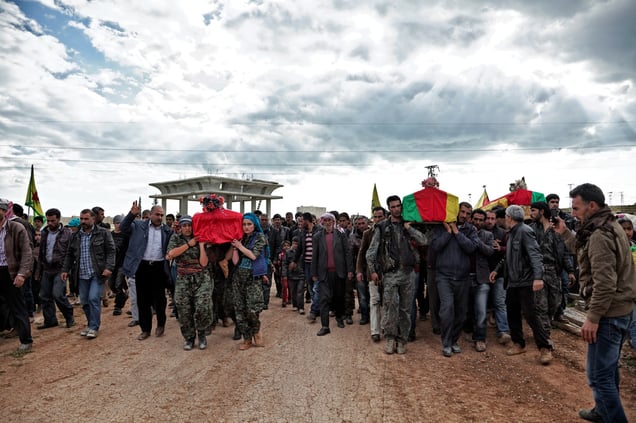 14 April, 2015: A group of YPJ (Women's Protection Units) and YPG (People's Protection Unit) fighters carry the coffins of Kurdish fighters who were killed during clashes with the Islamic State in Eastern frontline of Kobane, Syria.