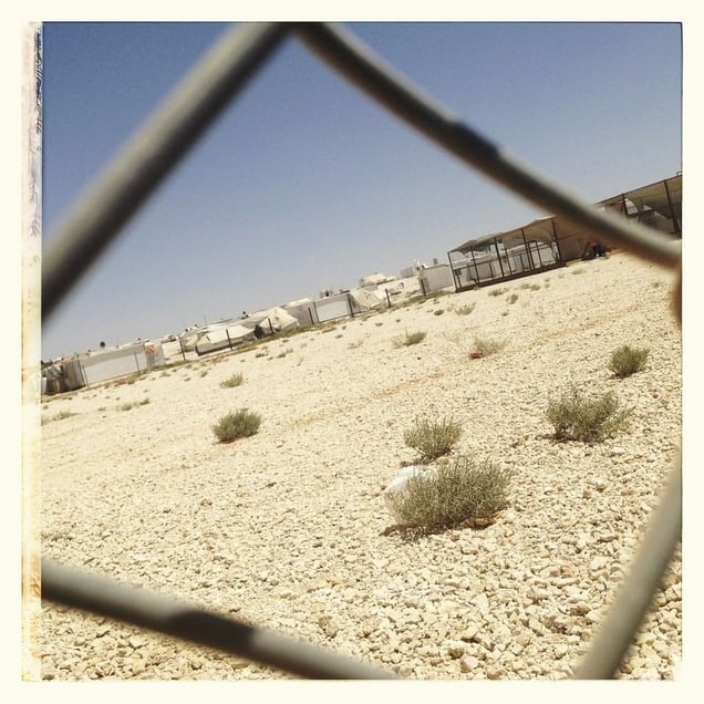 Looking through a fence towards the basketball court at a Save the Children supported multi-activity centre