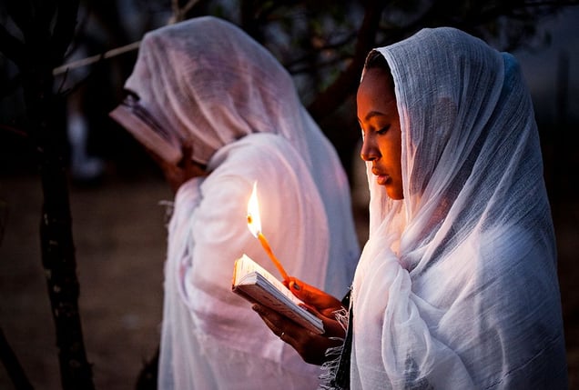Lalibela, Ethiopia: Two young worshippers are reading the Old Testament during the old Christian (orthodox) celebration of Timkat. © Matjaz Krivic