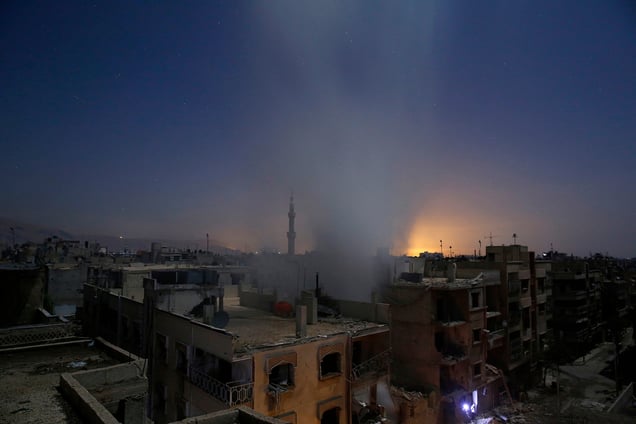 Smoke rises from a building following reported shelling by Syrian government forces in Douma, Syria, 30 October 2015.