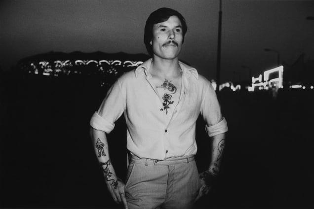 Tätowierter vor Karussells, Leipzig 1981, from Infrared Night Shots (1980-1982) © Erasmus Schröter (Germany), from the exhibition Behind Walls: Eastern Europe before 1989. Courtesy of the Noorderlicht Photofestival 2008.