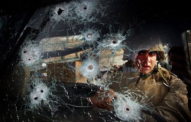 2nd prize General News Singles © David Robert Swanson, USA, The Philadelphia Inquirer, U.S. marine in ambush, Ar Ramadi, Iraq, 6 April. Private Eric Ayon of Echo Company of the Second Battalion, Fourth Regiment of the US Marines stares through the bullet-riddled windshield of a Humvee ambushed at Ar Ramadi in Iraq on April 6. Eight out of the nine marines on board were killed.