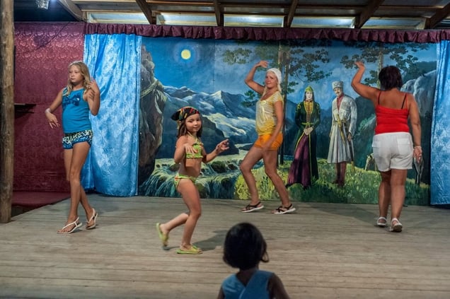 Russia, Kalej Tourists dance on the stage during a break in a folk show depicting the traditions of the Circassian people. In the villages between Sochi and Djubga there are numerous such places offering Russian tourists an 'authentic' experience of Circassian history and culture© Petrut Calinescu