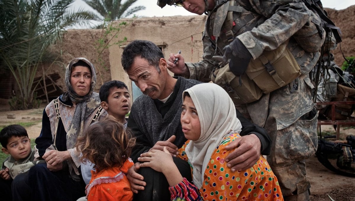Qubah March 24, 2007. A US soldier marks the hands of women and the backs of the necks of men with numbers according to their neighborhoods. Lt Col. Andrew Poppas of the 73rd Calvary, 82nd Airborne Division, said the numbering system allowed troops to determine if people were moving around the village of Qubah despite a lockdown following a US attack on insurgents. © Yuri Kozyrev/NOOR