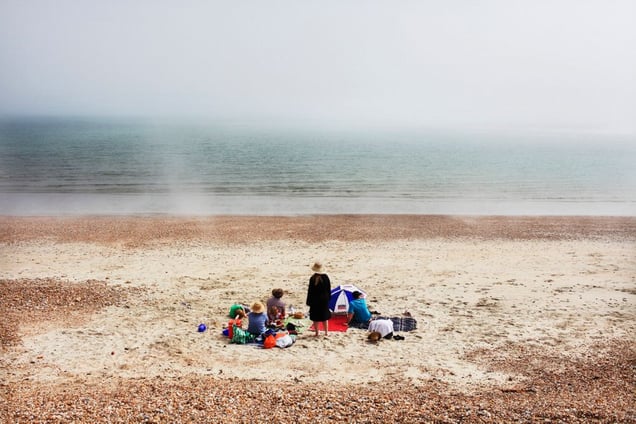 "It is mid-afternoon. The weather is sunny. Travelling in the south of England, I am walking on Hayling beach. A sudden fog comes down on the beach changing dramatically its atmosphere. A feeling of strangeness. I take a photograph of this family as I walk past. A few minutes later, the fog disappears, as fast as it came."