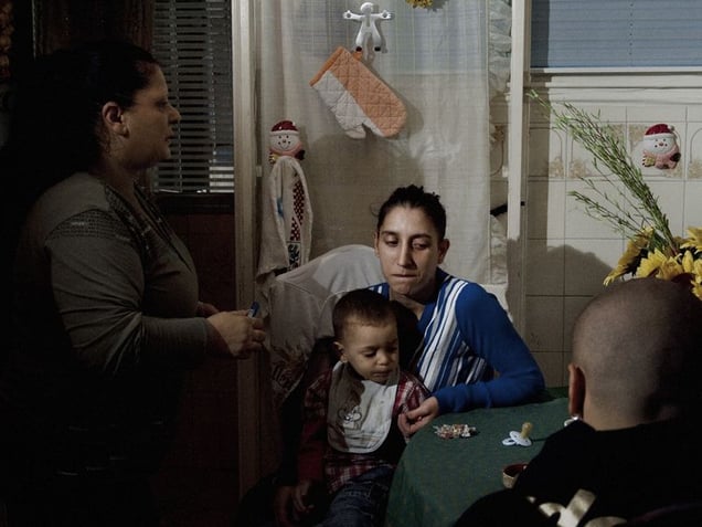 La Vela Rossa (The Red Sail), 9th floor, Scampia, Naples.
Francesca's mother with her sister's friend and son in their kitchen.
© Valerio Spada.