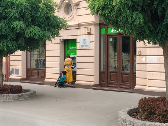 An ATM in Novi Sad, Serbia. The bank’s bright vinyl signage is inserted into an older commercial facade, creating a visible contrast between contemporary service infrastructure and the restrained architectural surface.