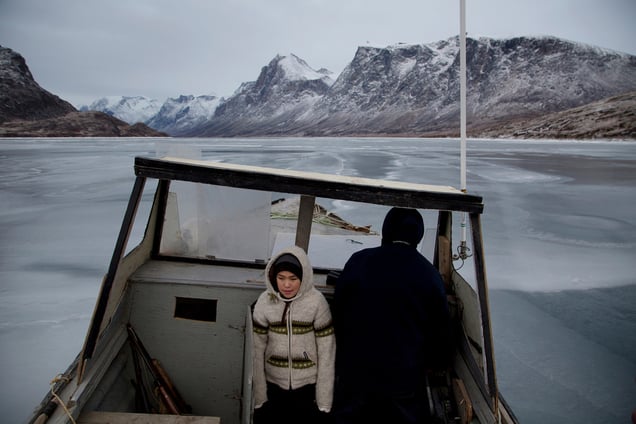 ANGNIRTUNG, CANADA - NOVEMBER 14  During a hunting trip, Damien Ishlutak (left), 10, and his father Levi (right), 35, hunt for seals from their boat in Pangnirtung, Canada on Nov. 14, 2013. Ed Ou/Reportage by Getty Images