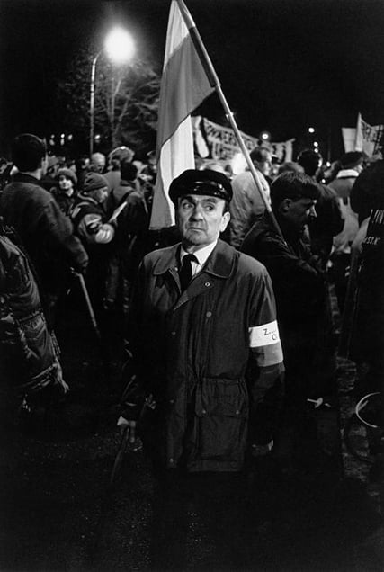 The newly recovered freedom of demonstration. A night gathering of WWII veterans that had suffered political prosecution, in front of the gates of the infamous political prison in Rakowiecka Street in Warsaw, a symbol of Communist oppression, 1989, from After-images of Poland © Witold Krassowski (Poland), from the exhibition Beyond Walls: Eastern Europe after 1989. Courtesy of the Noorderlicht Photofestival 2008.