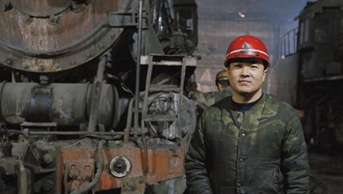 Railway worker at the train repair depot, Lutien Mine © Ollie Woods