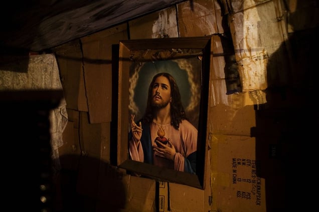 A portrait of Jesus hangs in a cardboard home in the Stara Gazela settlement in "old" Belgrade. © Matt Lutton