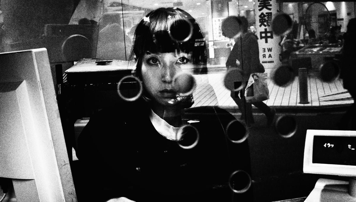 A sales girl at movie theater ticket counter