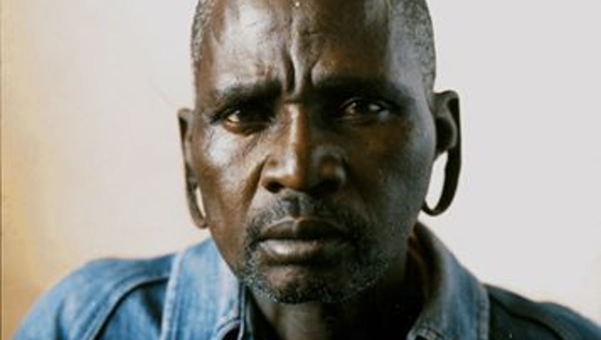 I came here when I was just a boy. That was what you did. You left home and came to the city to look for work. I lived alone in this hostel. Alone with 400 other men. It was dangerous in those days. The football field outside was often covered with blood. — Mr. Mkhize has lived in Madala hostel, in the heart of Johannesburg’s affluent suburbs for 15 years. © Adam Broomberg and Oliver Chanarin