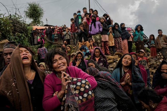 A woman cries as the body of her daughter is recovered from the rubble of her destroyed home. Gumda, Nepal, 08 May 2015.