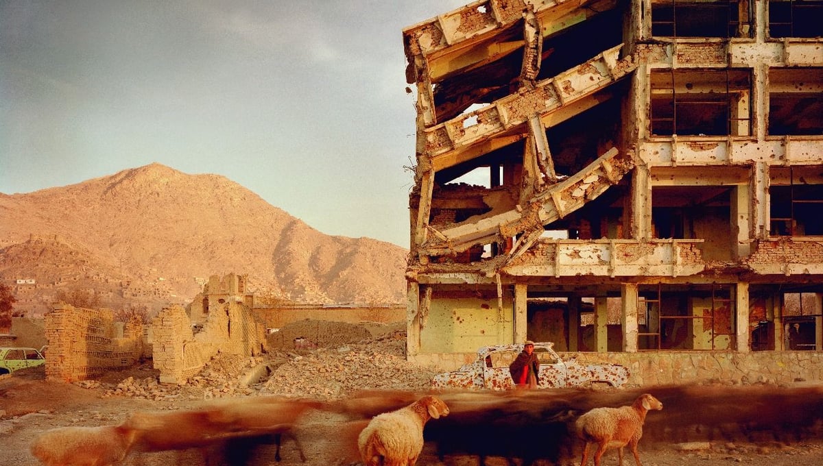 Bullet-scarred apartment building and shops in the Karte Char district of Kabul. This area saw fighting between Hikmetyar and Rabbani and then between Rabbani and the Hazaras  2003.