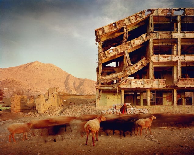 Bullet-scarred apartment building and shops in the Karte Char district of Kabul. This area saw fighting between Hikmetyar and Rabbani and then between Rabbani and the Hazaras  2003.
