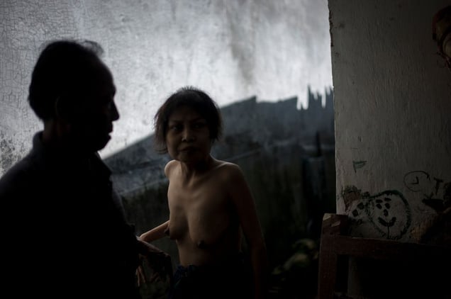 Indonesia, Bali, Singaraja, 16. April 2013 - Kadek, 42, for years she stopped to talk. She has spent more than half her life in a room without windows. Kadek lies on a cot. Her family believes she is possessed by demons. The family refuses that Kadek gets treated with Western medicine. So far They have visited 57 ritual healer, but nothing worked.  © Christian Werner