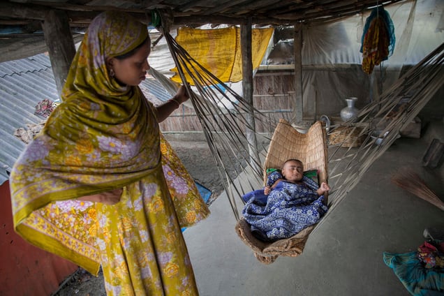 Rani Begum is 15 years old who was married at the age of 12, stands beside her child in Shyamnagar, Satkhira. Natural disasters in Bangladesh and the lack of an adequate government safety net for families affected by them, compound the poverty that drives child marriage.