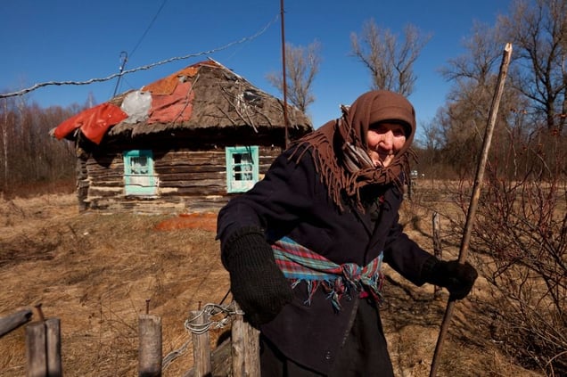Teremtsy, Ukraine, 2011. Kharytina Desha, 92, is one of the few elderly people who have returned to their village homes inside the Exclusion Zone. Although surrounded by devastation and isolation, she prefers to die on her own soil.