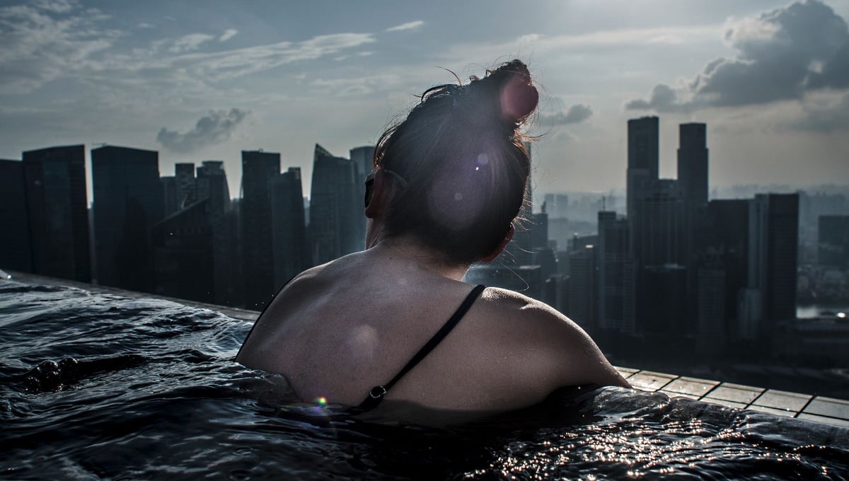 Future is getting harder,Waddling chest deep in the highest swimming pool of the world, I pause in amazement in the far distant horizon and studied the intense changes made to the landscape of Singapore. She too paused.Who would have imagined how far we would come. What we had to lose to come this far and what could we gain in the future? © Amrita Chandradas