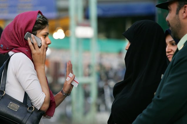A woman with a loosely-tied head scarf. Just before the hot summer months when women wear lighter clothing, Tehran police launch a campaign to crack down on women flouting the strict dress code. Women are not allowed to expose their hair or ankles, and must wear loose-fitting clothes that conceal the shape of their bodies. 50 new police squads that include female officers will help enforce the dress code. Tehran, IRAN - April 2006
© Copyright 1979-2009 Alfred Yaghobzadeh. All rights reserved.