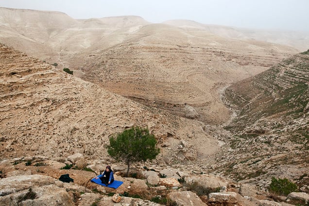 A young woman, from Zataara village on outskirts of Bethlehem in West Bank, practices yoga.