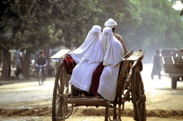 Kunduz, Afghanistan, 2002. Two women on a horse-drawn taxi. © Manoocher Deghati