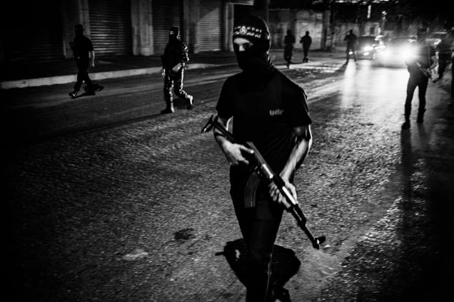 Fighters of al-Naser Salah al-Deen Brigades parade in the streets of Gaza at night