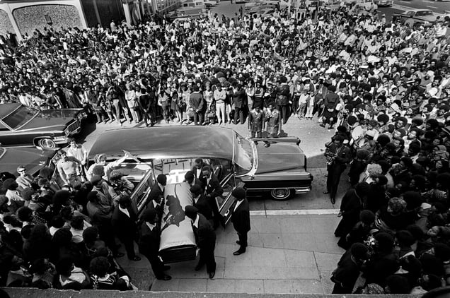 August 28, 1971 - Oakland, California, USA: Black Panthers carry George Jackson's coffin into St. Augustine’s Church for his funeral service as a huge crowd watches. In 1961, George Jackson was convicted of armed robbery (as a teenager stealing $70 at gunpoint from a gas station) and sentenced to serve one year to life in prison.