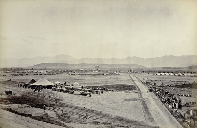 "Durbar in Sherpur Cantonments." © John Burke.
A thin crowd of onlookers watches a British ceremonial display before a tent crowded with dignitaries.