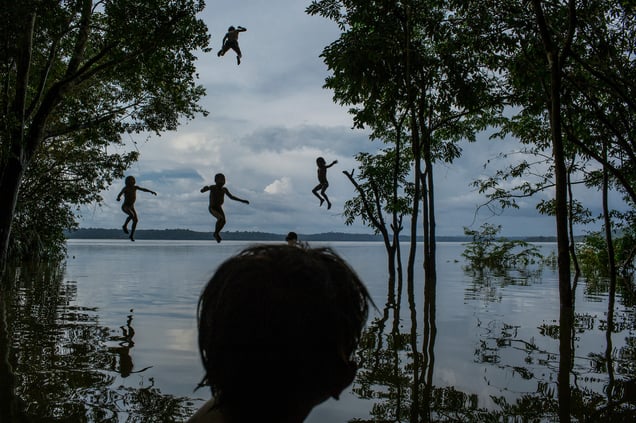 Indigenous Munduruku children play in the Tapajos river in the tribal area of Sawre Muybu, Itaituba, Brazil on 10 February 2015.