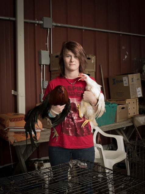 Kenzie Manns is a 15 year old high school student. She works weekends with her step father at the Pendergrass Flea Market in Pendergrass, GA for James Raven in his live poultry business. © Forest McMullin