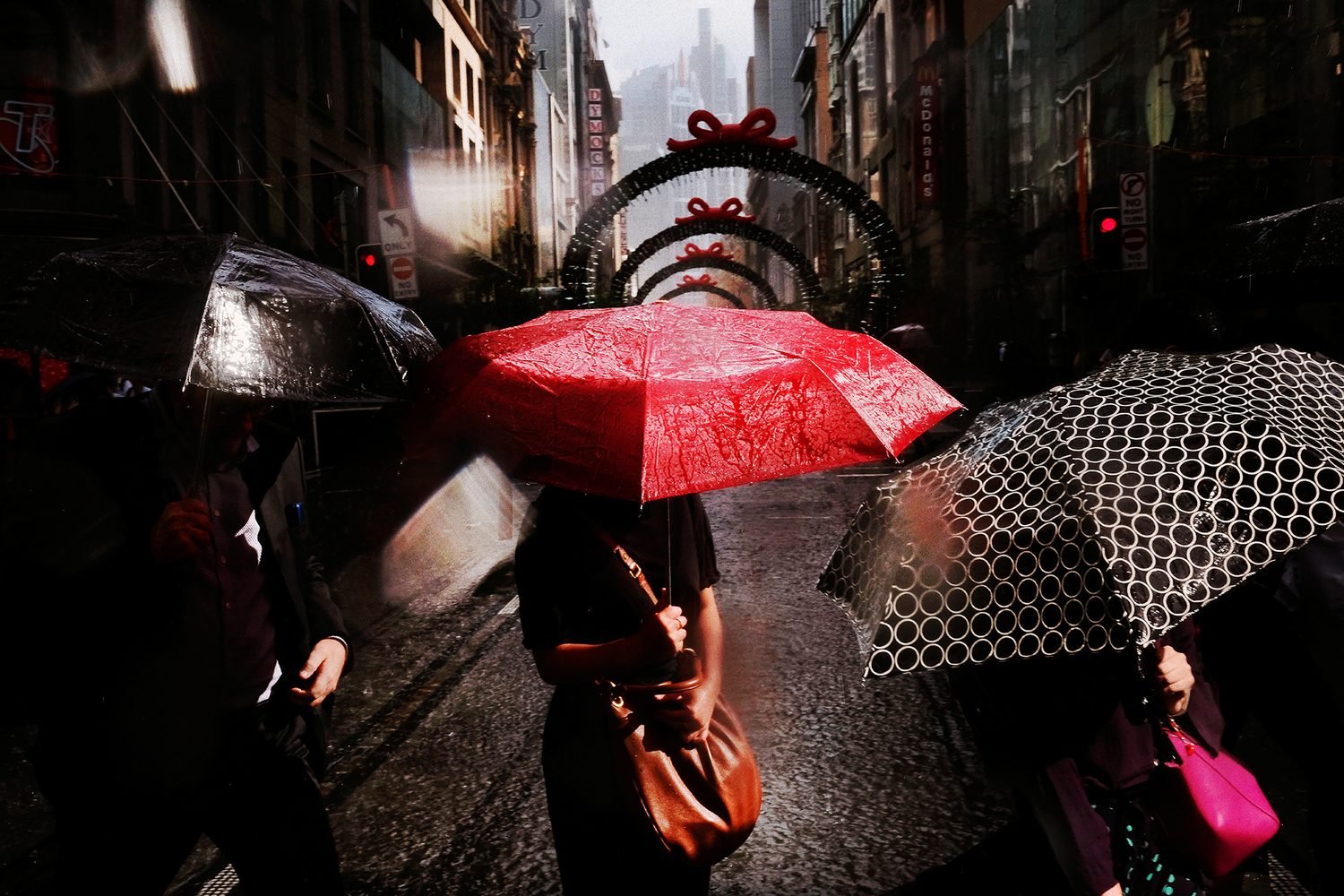 Light Rain on George Street. A Summer storm quenches the city and douses commuters during rush hour, after a hot and humid day in Sydney. © Sam Ferris