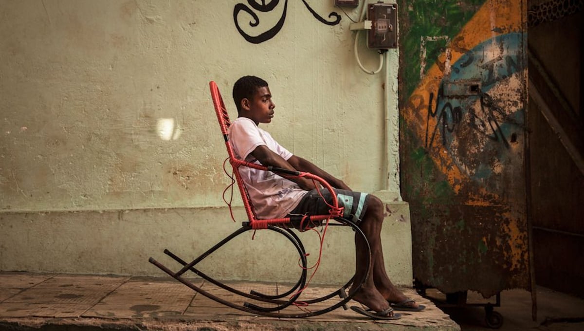 While the government claims that the UPPs are working, residents would disagree. Besides, the residents are hoping for more substantive changes, such as to their health care, education, water, transportation and employment opportunities. Above, a young teenager hangs out in the streets of Mangueira with nothing to do. © Manu Valcarce