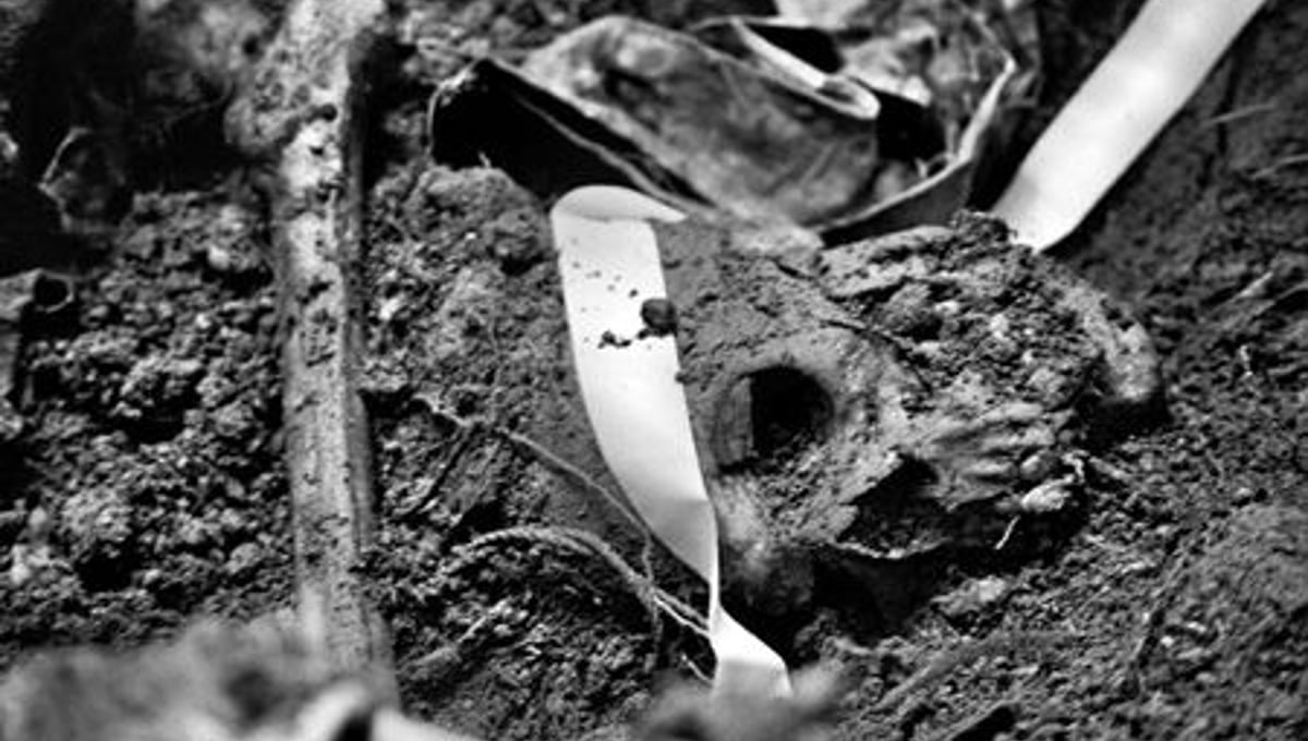 A skull lays in a recently opened grave. At the end of January, 135 bodies had been recovered from the exhumation at Comalapa. The number is expected in the end to be well over 200. © Victor Blue, 2004