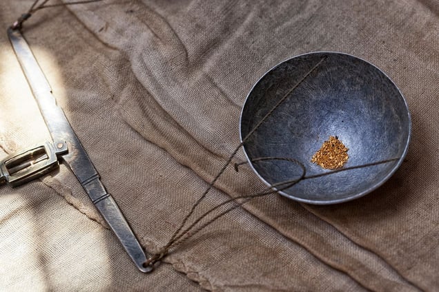 Small flakes of gold on an old scale ready to be legally sold to a government approved dealer at an official price. They will undoubtedly turn a blind eye to the children of the mines who suffer and die dreaming of their very own "El Dorado" for the sake of our smartphones. © Matjaz Krivic