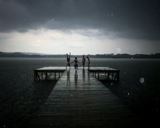 In your youth, nothing can stop you from enjoying time with your friends, especially not a simple matter of rain during summer fun. You may grow up and forget the names, but you'll always remember the moments, the time on the dock with your friends during a surprise shower © Samantha Fortenberry, United States. Shortlist, Low Light, Open Competition. 2014 Sony World Photography Awards