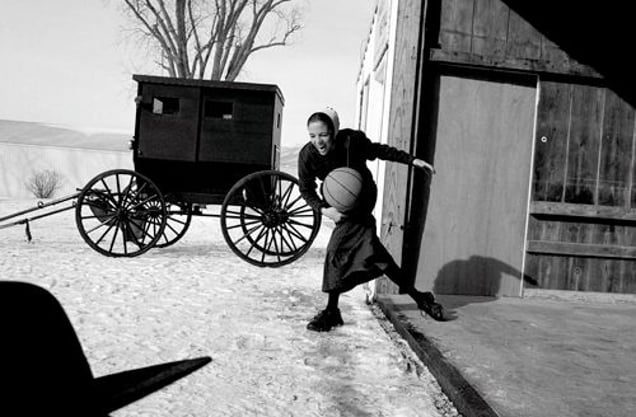 2nd prize Daily Life Singles © Krisanne Johnson, USA. Brethren girl, Ohio. A young woman of the Old Order German Baptist Brethren plays basketball at her parents’ farm in Ohio, USA, after dinner. Originating in a religious group that came from Schwarzenau in Germany in the early 18th century, the Brethren do not use electricity or cars.