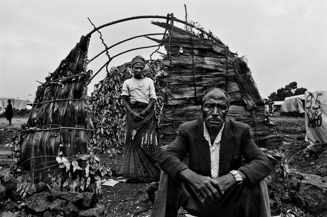 © Kate Geraghty (Australia) Godelive Ntamushobora, 45, with her husband Kadogu Sebishimbo, 60, in front of their half-finished makeshift home in the Kibati (IDP) Internally Displaced Persons' camp where tens of thousands of IDPs live, Democratic Republic of Congo. Honorable Mention, LensCulture Exposure Awards 2009