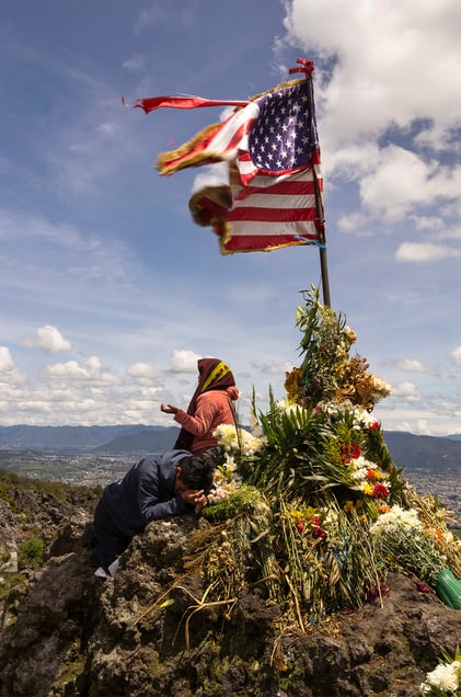 Locals and people across the region offering a prayer on the Almolonga volcano, also called Cerro Quemado, in Guatemala. The ancient Maya believed that volcanoes were holy places where the Gods and spirits resided. Cerro Quemado is considered one of the best places to get close to the Gods. Thats why people come from all over the region to pray and perform ceremonies, bringing flowers and sometimes food and alcohol to leave as offerings to God and the ancestors. Some people also believe that Juan Noj, a supernatural Maya being lives in the volcano.