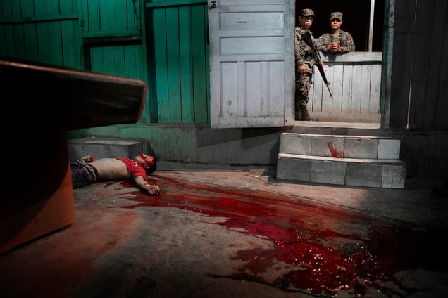 The body of a victim killed in gang-related violence. This is the fourth gang- related killing on the same street in one night. Police have no witnesses. San Pedro Sula, 4 March 2015.