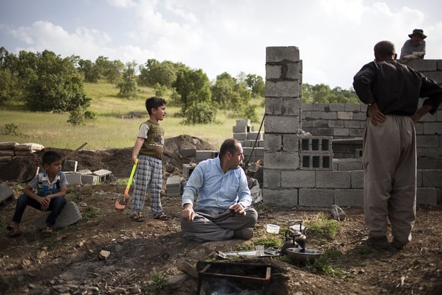 Tea break during the construction of a small house in a piece of land belonging to the aunt of Mohammed. 22/05/2015. Sharbazher village.