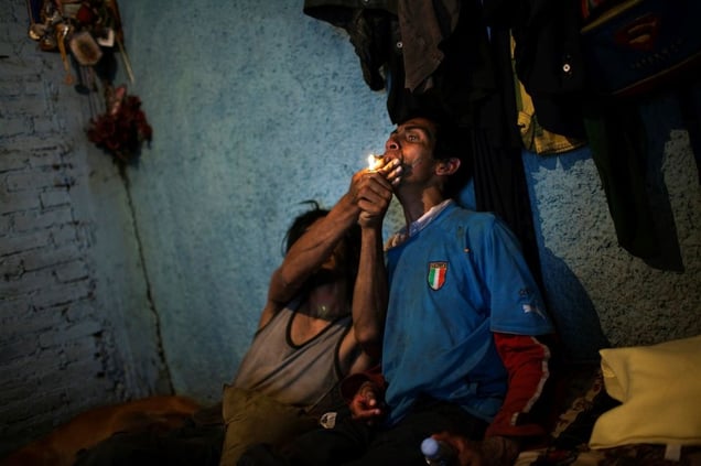 © David Rochkind, One man helps another smoke crack in Mexico City, from the series Heavy Hand, Sunken Spirit.  Honorable Mention, LensCulture International Exposure Awards 2010