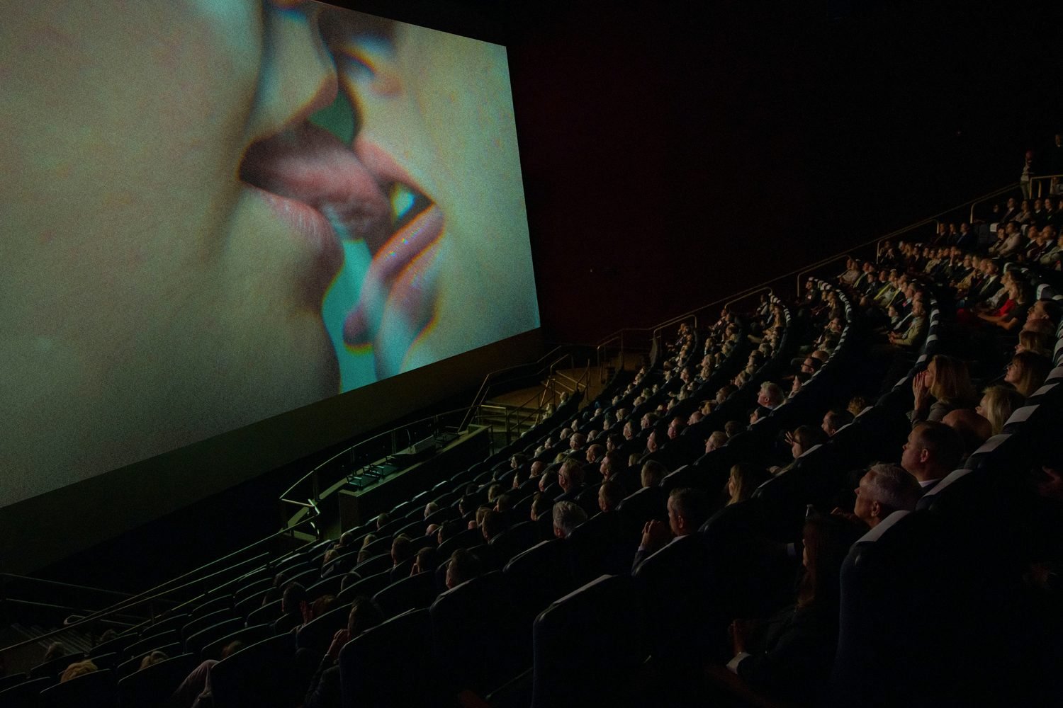 What are you watching? Manipulated NASA image of a film screening at the National Air and Space Museum. The screen has been replaced with an image of two women kissing. © Mackenzie Calle