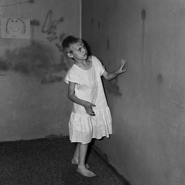 Girl in white dress, 2002, from the series Boarding House © Roger Ballen