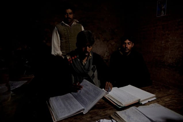 Office workers work late recording all the salt that leaves the Warcha salt mine. No computers exist here, so everything is documented in large books.