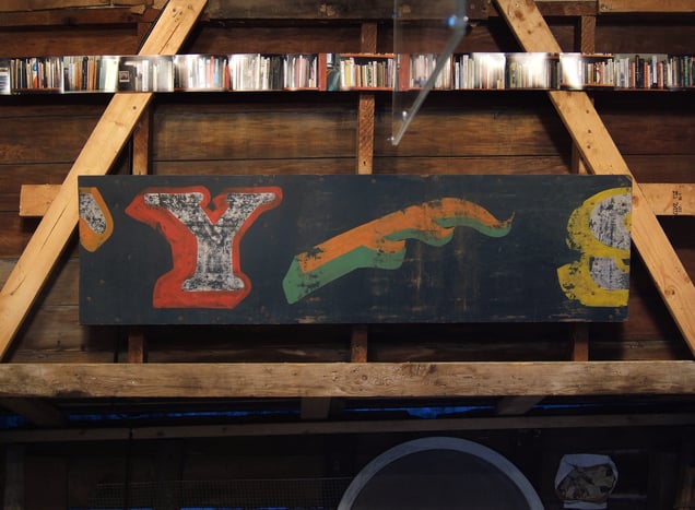 Found hand-painted sign, and (above) detail- 'Ex Libris: Self-Portrait as a Long Bookshelf,' altogether seventy-seven color photographic prints.